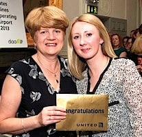 Pat Reede, United, presents Elissa Kelly, Eimer Hannon Travel, with her prize of two tickets to New York