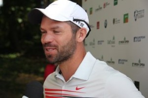 Paul Casey the defending champion,looks happy after his opening round. 
