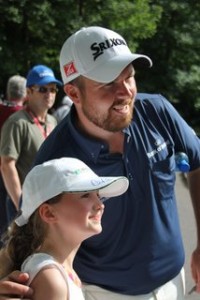 Shane Lowry gets his picture taken with a young fan .