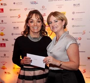 Tanya Airey, Sunway, receives her tickets for two from XXXX, British Airways