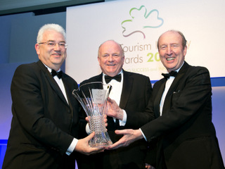 Vincent Harrison,Dublin Airport receiving the winning trophy from Paul Carty and Minister Shane Ross TD.