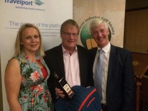 Sinead Reilly,Travelport presents Martin Dempsy with his prize as Martn Skelly looks on.