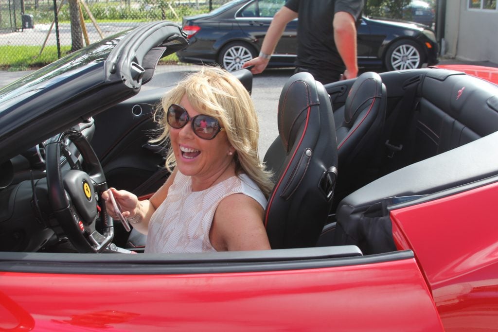 Sandra Corkin,Oasis Travel gets ready to experience the Ferrari convertible.