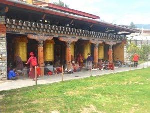 While families circumnambulate the chorten, elderly parents sit here, chat and spin the giant prayer wheels