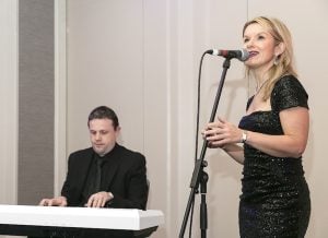 …arriving guests are entertained by singer Stella and her pianist…