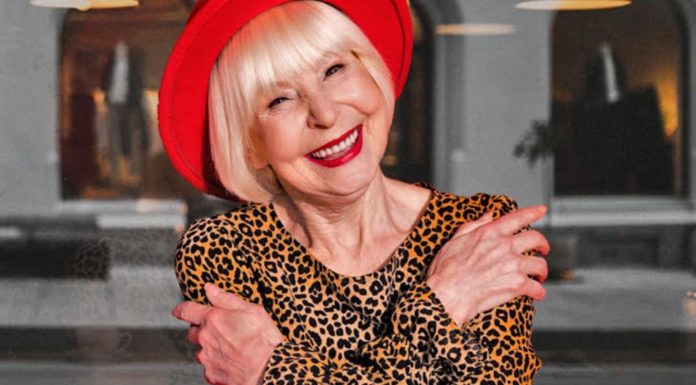 Hear Directly from the Women in Irish Travel Trade on International Women’s Day A woman in a red hat, blond short hair and a leopard print top posing for International's Women's Day photo